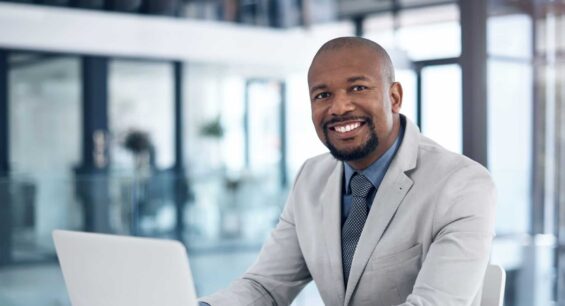 Shot of a confident businessman using a laptop in a modern office
