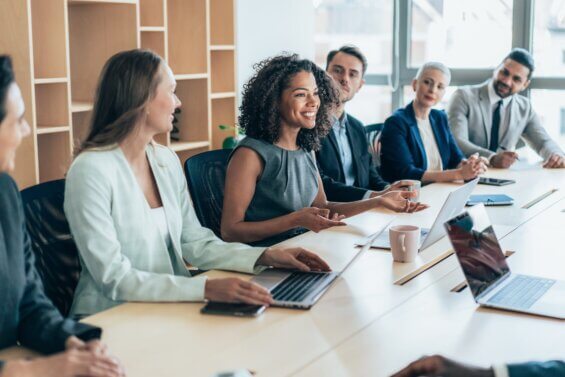 Multiethnic group of businesspeople sitting together and having a meeting in the office.