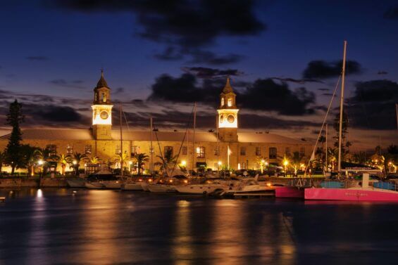 A historic building in Bermuda lit up at night.